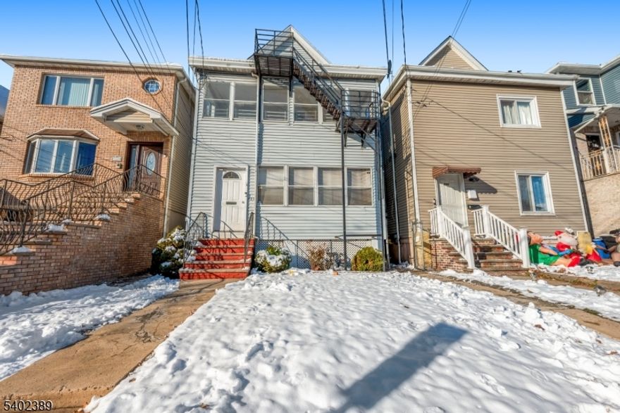 Second-floor apartment featuring a formal living room and dining room, plus an additional small room ideal for a home office or guest bedroom. Conveniently located near local grounds and amenities.