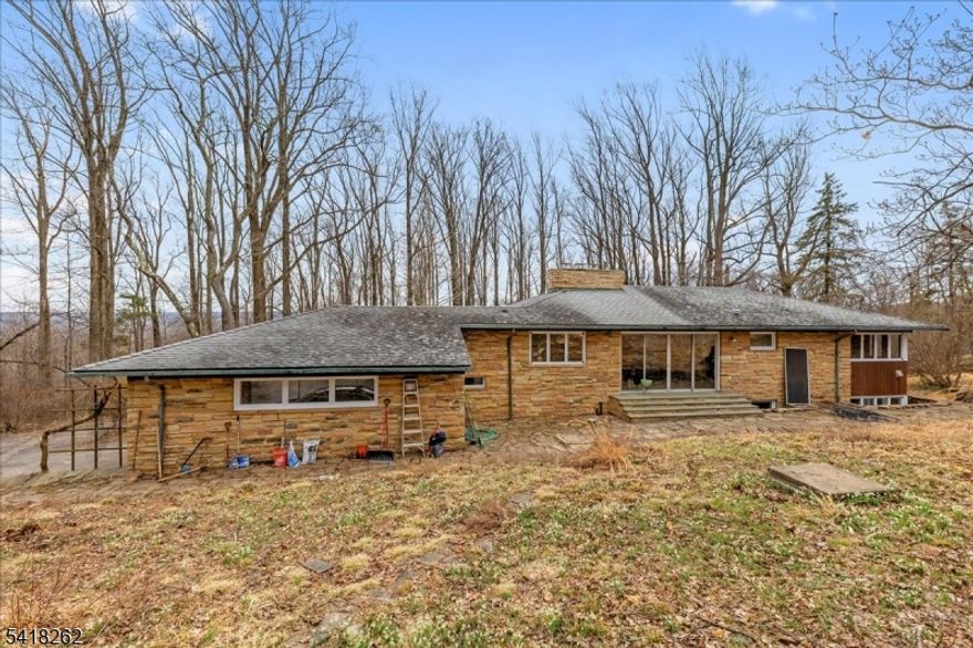 Discover a rare opportunity to own a unique Mid-Century Modern retreat set high on over 17 private acres in beautiful Skillman. Surrounded by nature and complete privacy, this exceptional property offers breathtaking sunset views and a peaceful setting that feels like your own secluded sanctuary.The home features 3 bedrooms and 1 full bath, blending timeless architectural character with warm, inviting living spaces. The living room  is wrapped in dramatic floor-to-ceiling windows, creating a stunning connection to the outdoors and filling the home with natural light throughout the day. From this vantage point, you'll enjoy sweeping views of the surrounding landscape and unforgettable sunsets while enjoying the built in fireplace.At the heart of the home, the kitchen features a charming fireplace, perfect for cozy meals and gatherings. A second fireplace in the living room adds warmth and atmosphere.The lower level offers a comfortable family room with an additional stone fire place, plus two additional versatile rooms, ideal for a guest suite, home office, gym, hobby space, or studio.Two-car garage and expansive land that offers endless possibilities whether you envision trails, gardens, outdoor entertaining spaces, or simply preserving the tranquility and privacy of the property.Located within the highly sought-after Montgomery school district, this property combines natural beauty, architectural charm, and a prime location.This is a two lot sale (17.53 acres)