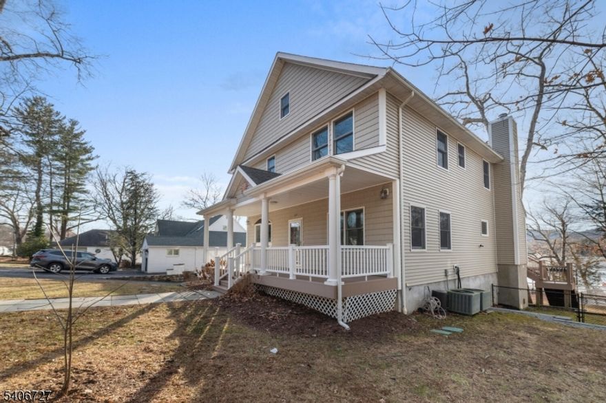 Are you looking for a 4 bedroom 4 full bath lakefront home on the eastern shores of Greenwood Lake in a private lake community with public utilities, private beach, clubhouse, tennis courts, & playground?  Welcome to 212 Long Pond Road, located in the community of Awosting!  Featuring 3 levels of living, this home features hardwood flooring throughout, updated kitchen & baths, radiant heating on the main level, multi zoned central air, wood burning fireplace in the living room, 1 car garage, fully floored attic for storage, & a finished basement.  Nothing to do but move in & enjoy lake life, including the 2 exterior decks (with awnings), covered front porch, & your own covered dock on the water.  With western views, you'll never miss a sunset!  This home was renovated in 2023, with new flooring, kitchen, paint, drywall, light fixtures, & the list goes on...  Come see this home for yourself!