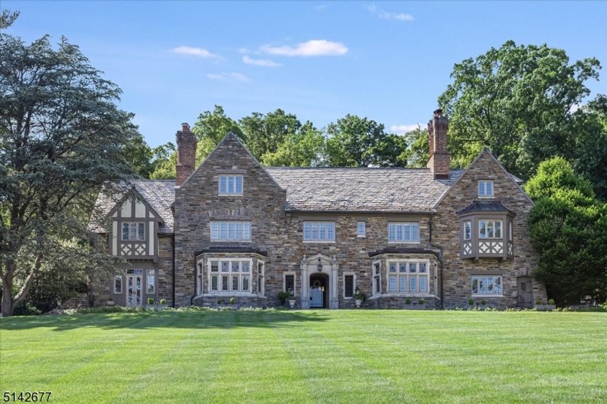 Situated on Highland Avenue, you can experience the most breathtaking sunrises over the NYC skyline and magnificent views of New York City lights at night. This stone English Manor home, set on 2.5+ acres, features unmatched historic detail w/state of the art finishes. Restored and renovated by Jack Finn, spectacular detail includes 4 fpl, coffered ceilings, ornate plasterwork, leaded + stained glass windows and magnificent carved woodwork. Each room is breathtakingly beautiful and elegant. Formal rooms on the 1st include the Living Rm w/fpl, Dining Rm w/fpl, Library w/fpl and Family Rm w/fpl. The gourmet Kit features custom cabinetry, granite counters + stainless steel appliances and separate Breakfast Rm. Upstairs the fantastic Primary  Suite includes spectacular Bath suite w/19x19 Closet/Dressing Rm, Bath, Dressing/Makeup Area + Sitting Room. There are 3 additional Bdrs and Bths on 2nd floor +office. The 3rd flr has 2 Bdrs + Bath, large office + Game Room. The Basement has a huge Fm Rm w/fpl, Gym, and a spa like Steam Shower and multiple person sauna. The backyard is a resort-like oasis with  pool + waterfall, luscious landscaping w/hydrangeas + ferns and newly built cabana/pool house with Kitchen, Bar, Bth, changing room, and even a Laundry. A large level grass field provides space for hours of fun +play.  In addition to this glorious home and its professionally landscaped grounds, there is a 2 Bdr Carriage House above the 3 car garage. Property backs onto parkland.