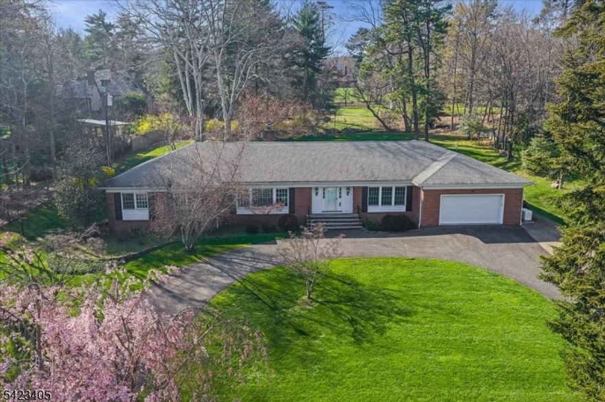 **ZILLOW'S TAXES ARE INCORRECT,  Current annual taxes are $34,447.**Stunning no-step ranch located in the prestigious Llewellyn Park, set on nearly one acre within a private gated community offering security, tranquility, and natural beauty. This 4-bedroom, 2.5-bath home features true one-level living with an ideal open floor plan. Sun-filled interiors showcase gleaming hardwood floors and spacious rooms throughout. The updated kitchen flows seamlessly into a custom TV room with spectacular built-ins, perfect for everyday living and entertaining. A dedicated home office with a separate entrance provides flexibility for work-from-home or professional use. Additional highlights include an attached 2-car garage and a massive unfinished basement offering endless potential for a home theater, gym, recreation space, or additional living area. Enjoy outdoor living on the magazine-worthy patio overlooking expansive, beautifully maintained grounds with lush lawn and mature greenery, providing exceptional privacy. Conveniently located approximately 24 miles from Midtown Manhattan, offering access to world-class dining, shopping, and commuting options. A rare opportunity to own a premier property in one of New Jersey's most sought-after gated communities.