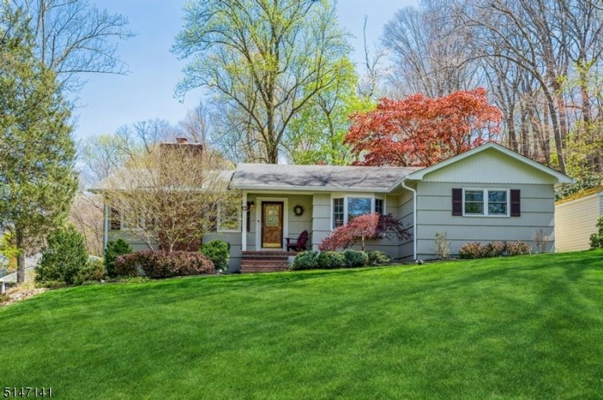 A spacious design and sprawling property in an unbeatable location!  Bright and expansive Ranch with 3BD/3BTHs an attached 2-car garage is nestled on an oversized, landscaped corner lot on a picturesque street in Morristown. Highlights include an updated kitchen, rich hardwood floors, crown molding in the living room, abundant windows letting in lots of natural light, a huge deck, finished basement, to name just a few.A semi-circular driveway and front porch lead you inside to the foyer & a spacious & LR showcasing a natural stone fireplace & views of the private property. The open flow takes you to the DR with a built-in dry bar & wine refrigerator that's perfect for entertaining. The bright, eat-in kitchen is updated with quartz counters, sparkling white cabinetry, SS appliances & a skylight bringing in even more sunlight. Throw open the French doors to the gorgeous deck w/a hot tub overlooking the patio, lush lawn & woods beyond. The family Room is warm & inviting. The layout continues to the primary bedroom with an en suite bath, 2 additional bedrooms & a full hallway bathroom. The finished basement offers a spacious rec-room, an exercise room, a full bathroom, laundry room w/a laundry chute, lots of storage & a partially finished room that could be used as an office. This home is just minutes to the NJ Transit train station, near schools, stores, restaurants, golf clubs, and park