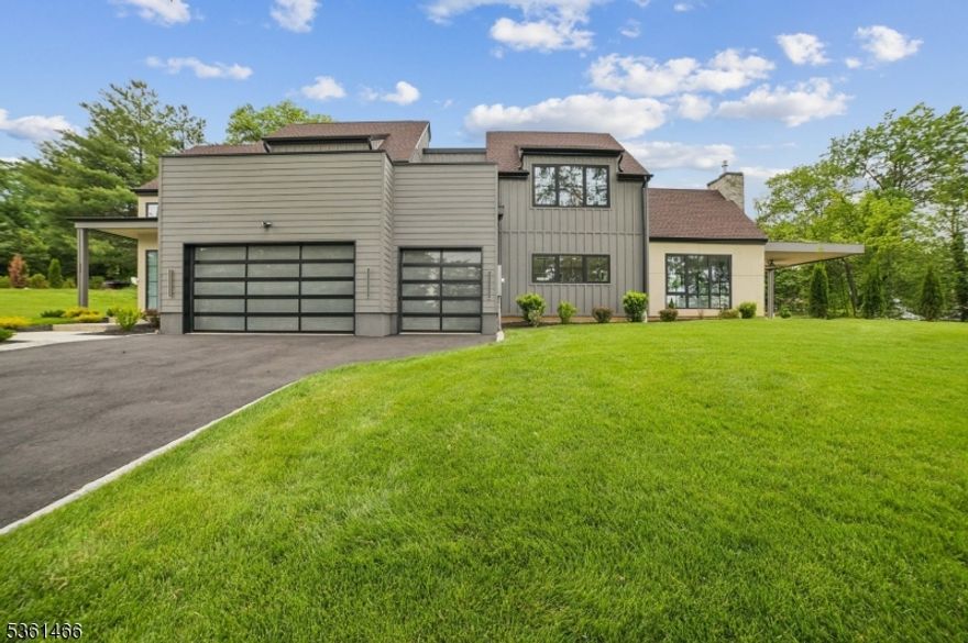 Crafted with exceptional attention to detail, this newly constructed 5-bedroom, 4.5-bath home offers over 4,000 sq ft of luxurious living. Step into a soaring 23-ft foyer that sets the tone for the custom design and modern amenities throughout. The open-concept main level features radiant heated porcelain tile floors and a show-stopping gourmet kitchen with quartz countertops, a 48" ZLINE range and S/S ZLINE appliances, custom 54" Finewood soft-close cabinetry w/accent lighting, massive center island w/seating and a built-in wine cooler, under cabinet lighting and a pantry. A first-floor bedroom with a private ensuite bath adds both flexibility and convenience. Triple-pane windows bathe the home in natural light, and the family room impresses w/cathedral ceilings and a sleek gas fireplace that opens to an 18' x 18' covered patio for effortless indoor-outdoor entertaining. A floating oak staircase leads upstairs to four spacious bedrooms and spa-inspired baths with touchless bidet toilets and heated floors. The exceptional primary bath includes dual sinks, soaking tub, stall shower and a WIC. Additional highlights include a laundry room on each level, tankless hot water heater w/instant hot water throughout the home, 3-car garage w/custom glass doors, underground sprinklers, 1,000 gallon sewer pump for a clog-free sewer line and a 2nd story terrace offering a serene outdoor retreat. Nestled on a beautifully sodded lot with curated landscaping - this is modern living redefined.