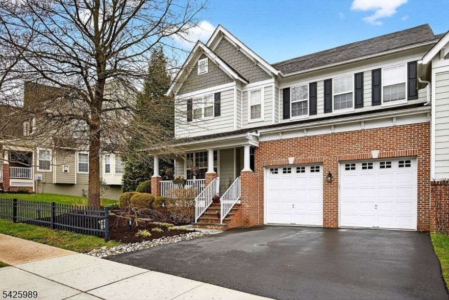 Perched above the Delaware River Valley in the coveted Lambert's Hill community, this exceptional end unit offers breathtaking sunset views and a lifestyle defined by beauty and ease. Just moments from Lambertville with easy access to New Hope, Frenchtown, and scenic river towns, the location is truly unmatched.A welcoming front porch leads into sun filled interiors with rich hardwood flooring, elegant millwork, decorative columns, tray ceilings, and crown molding. Expansive palladium windows frame picturesque views and bring the outdoors in.The kitchen is designed for gathering, featuring a large granite island, tumbled marble backsplash, premium stainless steel appliances with a six burner range, and a farmhouse sink overlooking wooded views. The breakfast area opens to a maintenance free deck, perfect for dining and relaxing.The two story great room impresses with soaring ceilings and a gas fireplace, flowing into a comfortable family room for everyday living.Upstairs, the primary suite offers sweeping views, two walk in closets, and a spa like bath with soaking tub, dual sinks, and glass enclosed shower. Two additional bedrooms, a full bath, and linen storage complete the level.The finished walk out lower level includes a bedroom, half bath, and flexible space with access to a bluestone patio and yard.Additional highlights include designer paint, a two car garage, and a whole house Generac generator.