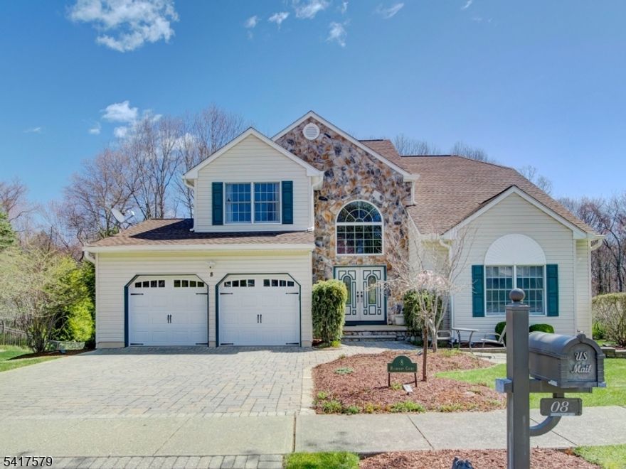 Welcome to this beautifully maintained home in one of the most sought-after neighborhoods in Succasunna. Offering an open floor plan, this home blends comfort, style, and functionality, and sits at the end of a cul-de-sac on a lot that backs to woods with a full walkout basement. A stunning 2-story foyer with a dramatic palladium window fills the space with natural light. The updated kitchen features granite countertops, custom cabinetry with built-in organization, a pantry, newer refrigerator and dishwasher, a 4-year-old Frigidaire microwave, and a 5-burner range, plus a separate dining area. The adjacent family room includes a cozy wood-burning fireplace.The dining room showcases unique Canadian white frost hardwood flooring and flows into the living room with a vaulted ceiling. The first floor also offers a powder room and a spacious laundry room with garage access. Upstairs features newer carpeting and generously sized bedrooms, all with custom California Closets. The primary suite includes a dual vanity, soaking tub by Jacuzzi, separate shower, and walk-in closet. The finished basement adds flexible living space with a dry bar, storage, and areas ideal for entertaining, office, or gym. Additional highlights include crown molding, underground sprinklers, gorgeous paver driveway, generator hookup, a 6-year-old roof, and public utilities.  A MUST SEE!