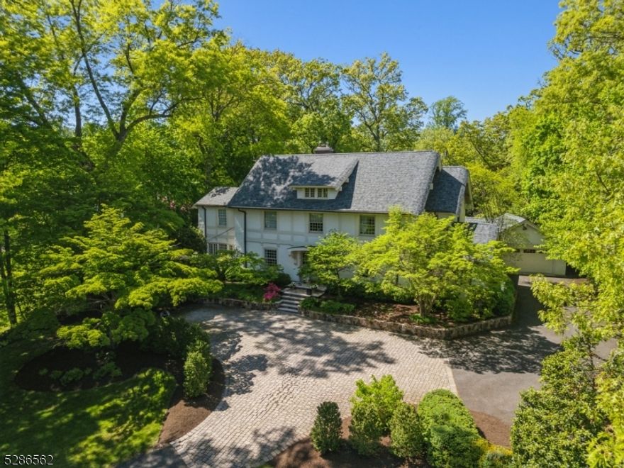 This exceptional residence boasts an unparalleled blend of timeless elegance, architectural interest, modern amenities and exquisite craftsmanship with a flexible floor plan designed for everyday living and entertaining. This classic is ideally set on .82 perfectly landscaped acres and is just a block from Madison's thriving downtown, NYC trains and schools. As you step inside, a lovely foyer welcomes you into this home with large living room enjoying two sitting areas, a wall of builtins and fireplace, a cozy den with three walls of windows, a banquet sized dining room, sunroom, chef's kitchen that opens to a breakfast room and family room with soaring ceilings and a first floor laundry and mudroom. The second level features a luxurious primary suite, a spacious sanctuary boasting a spa like bath with tub and stall shower, sitting room with gas fireplace and two walk in closets, a private office, newly renovated full bath and two other bedrooms completes this second floor. The third floor features 3 more bedrooms and a newer full bath. The lower level enjoys a recreation room, media room, and wine tasting room with cellar. The allure of this exceptional residence extends beyond its interiors to the meticulously landscaped grounds with an expansive lawn, two blue stone patios, meandering stone walls and stately curb appeal. Many updates include a newer roof and gutters, furnace, 3 renovated full baths and a powder room, newer windows, A/C compressor and so much more.