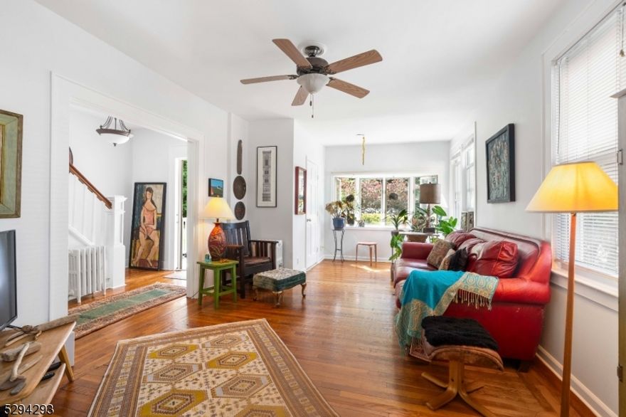 Welcome to this stunning Colonial home that exudes charm and elegance. Located just a few blocks from the train station and downtown Cranford, this residence offers both convenience and tranquility.  Abundant natural light fills every room, creating a warm and inviting atmosphere. Main floor with inviting living room and dining room with hardwood floors, featuring also a powder room and an amazing eat in kitchen with access to the green and airy backyard through the sliding doors. Second floor with 3 bedrooms and full bath. The expansive, unfinished attic offers endless possibilities for customization, whether you envision a home office, playroom, or additional living space. The unfinished basement provides ample storage space and potential for future projects. A brand-new driveway enhances the curb appeal and offers plenty of parking. Freshly painted interiors provide a clean, contemporary look throughout the home. The serene backyard is the perfect retreat for relaxing summer days and outdoor entertaining. Ideally located with easy access to major highways for commuting. This home seamlessly blends modern updates with classic Colonial charm, making it a perfect choice for those seeking style, comfort, and convenience. Affordable taxes! Don't miss the opportunity to make this beautiful property your new home!