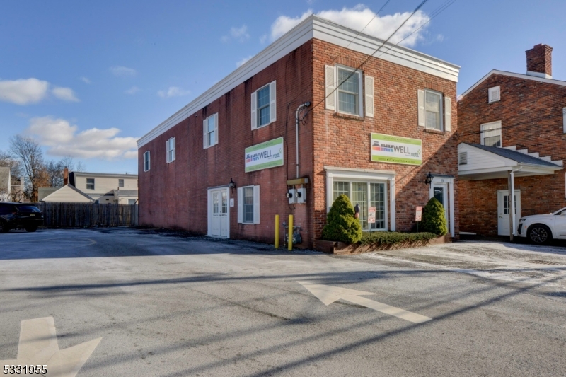 This two-story 3,430 sf block & brick building sits on a 2,778 sf level lot and is adjacent to a large community parking lot.  This standalone building built in 1986 is located half block off of Kenilworth's main street ("Boulevard") and presents an opportunity for both owner/occupants as well as landlord/investors.  Recent renovations throughout the entire building include new Anderson double-hung windows with insulated glass,and new LED overhead lighting.  Each floor has separate meters for electric, water, gas & HVAC.  All systems are clearly marked and easily accessible. Two rooftop HVAC units have been rigorously maintained under a continuous service contract with local service contractor.  Both first and second floors share a common entry/foyer where steps lead immediately up.  The first floor tenant uses the side double doors for easy loading in the parking lot for easy entry and/or unloading.  The current tenant in this space is a thriving corporate graphics company with a lease that remains until March 31, 2026.  Second floor is vacant, full of light and has a similar floor plan to the first floor.  It has a large open space suitable for training large groups or creating a loft-like work environment. Space on both floors is easily reconfigurable. The building is on a slab foundation.  There are three assigned parking spaces in front of the building. This is a solid, clean, sun-filled building.  **Business is NOT for sale**