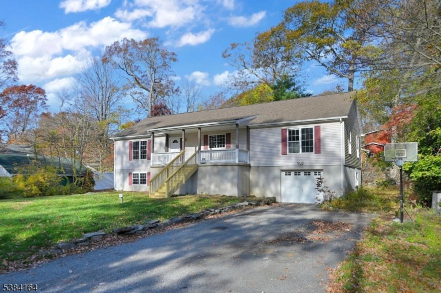 Welcome To This Bright And Inviting 2 Bedroom, 2 Bath Raised Ranch Set In Upper Greenwood Lake! This Home Features An Open And Comfortable Layout With A Spacious Kitchen Offering A Center Island, Bar Seating, Pantry, And Plenty Of Cabinet Space. Enjoy The Warmth Of The Wood-Burning Fireplace In The Living Room, Complemented By Ductless Central Air For Year-Round Comfort. The Primary Suite Includes A Walk-In Closet, Jetted Tub, Dual Vanity And Separate Stall Shower, Creating A Private Retreat. Bedrooms On Opposite Sides Of The Home Provide Added Privacy And Space, While A Bonus Room/Office Adds Flexibility For Work Or Hobbies. The Unfinished Basement Offers Endless Potential, Easily Finish For A Recreation Area, Gym, Or Your Personal Vision. Exterior Highlights Include A Covered Front Porch, Attached One-Car Garage, And Level Lot. Located In The Scenic Upper Greenwood Lake Community, With Optional Membership Granting Access To The Private Beach, Clubhouse, And Lake Amenities. Conveniently Close To Sussex County And The NY State Border, Enjoy Nearby Farms, Orchards, Hiking, Skiing At Mountain Creek, Wineries, Breweries, And Local Shops. Low Taxes - Schedule Your Private Showing Today!