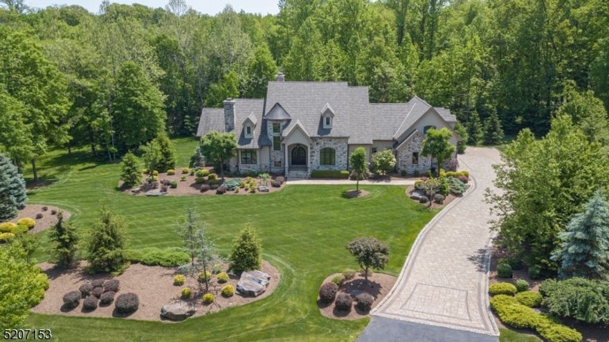 Superior craftsmanship and appointments are found in this custom 10-yr old home. The most discerning buyer will appreciate the high-end Details and finishes in nearly 5000 sq ft of living space. Sitting on almost 3 acres off a private road, this home offers a first-floor primary BR with separate baths and closests. The kitchen spotlights Birchcraft custom cabinetry, granite countertops, dual Sub-Zero fridge/freezers and Wolf and Miele appliances including a built-in coffee maker. The oversized walk-in pantry has a plethora of storage, as well as a s/s farmhouse sink and s/s dishwasher. While the first floor BOAsts 10' ceilings, the family room has a two-story ceiling, as well as a masonry wood-burning fp. The office features custom oak built-ins and millwork, gas fp and leaded-glass door. A second-floor BR offers an ensuite marble bath, vaulted ceiling and private balcony. A flex room allows options for an upstairs office, gym or playroom. Two immense storage closets are also found on the second floor. Basement has a newly finished 660+ bottle wine room with concrete walls for a modern feel and an adjacent large, unfinished space with 9' ceilings for your designing. Oversized glass french doors open from the family room to a covered PA bluestone patio. It features a wood-burning fp and built-in Lynx s/s grill and refrigerator. The perfect setting for entering or daily living. Buyers to confirm 2023 taxes based upon new assmnt in MLS.