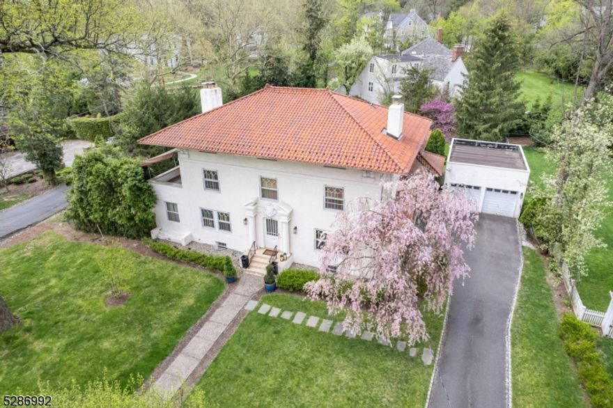 Elegance, sophistication, and gorgeous original details abound in this pristine move-in ready 7 Bedroom, 5.2 Bath European-Style Manor home in a scenic Old Short Hills neighborhood with a charming lake. Short distance to Glenwood School (.6 mile) and Midtown Direct Train (.9 mile), and convenient to both downtown Millburn and Summit restaurants and shopping. Traditional craftsmanship and moldings, open floor plan, hardwood floors, exquisite Kitchen with sleek custom cabinetry and top of the line stainless steel appliances. Elegant Living and Dining Rooms " both with fireplaces. Home Office(s). Family Room. The BEST Covered Patio overlooks   Acre of magnificent sun-drenched property with plenty of room for a pool. 2nd level features spacious Primary Suite, Walk-In Closet, fireplace, spa-like ensuite bath, and a private Terrace. 2 other generous bedrooms with Jack and Jill Bath. Bedroom 2 is very bright and has a decorative fireplace and Bedroom 3 has a private Terrace. Amazing Third Level with Home Gym, 3 Bedrooms, great closets, and 2 Full Baths. Huge Lower Level with oversized Recreation Room, Laundry Room, flexible storage/office areas, and ensuite Au Pair Suite with separate access. Don't miss this opportunity to own a modern stylish home combining traditional craftsmanship and contemporary design!