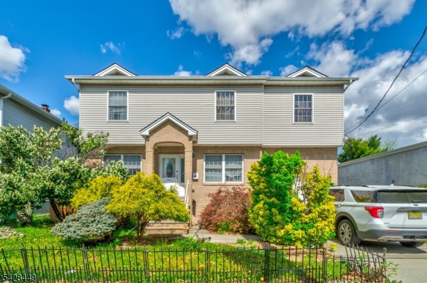 Welcome to this Center Hall Colonial offering 4 spacious bedrooms, 2 full baths, and 1 half bath, designed for both comfort and functionality. This home features hardwood floors throughout, recessed lighting, and a bright, inviting layout perfect for everyday living and entertaining. The large primary suite boasts a private bath with a relaxing jacuzzi tub and three closets, providing ample storage. Enjoy the convenience of 2-zone central air and heat, an oversized one-car garage, and a commuter-friendly location just under 10 minutes to Linden and Elizabeth train stations and approximately 15 minutes to Newark Airport, with easy access to NJ Transit, the NJ Turnpike, Routes 1 & 9, and nearby shopping plazas. Short Sale, Sold as-is don't miss the opportunity to make this your own!