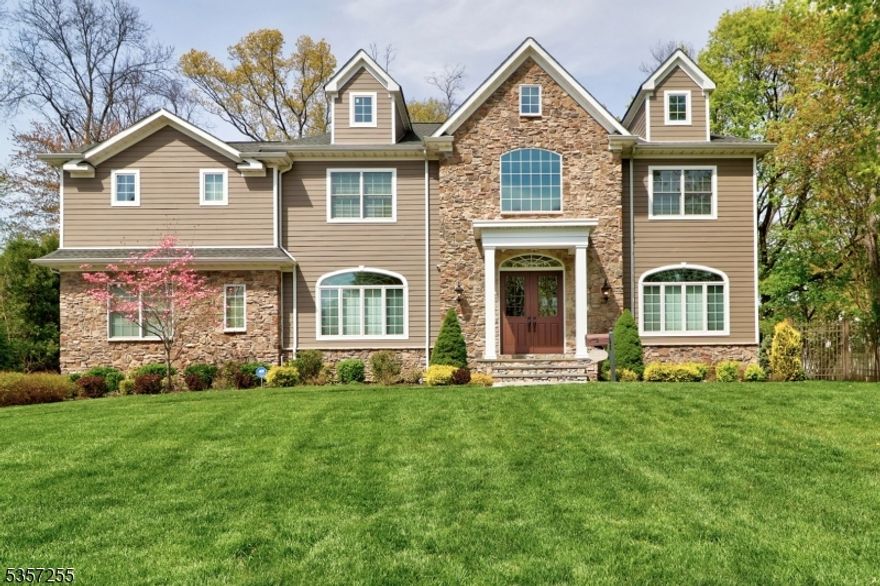 A Showstopper from every angle! This striking residence has been turning heads since the day it was built and it's easy to see why. The stunning curb appeal sets the tone, but it's what's inside that truly impresses. Soaring 10-foot ceilings on the main level, oversized 8-foot doorways, transom windows, and a dramatic two-story foyer create an open, airy feel throughout. The home is richly appointed with detailed millwork, thick moldings, and custom wood finishes that elevate every room. The first floor features formal living and dining rooms, a chef's kitchen overlooking the expansive family room, a butler's pantry, a generous bedroom with ensuite, and a 3-car garage. Head upstairs via the grand staircase or private back stairs to find five more bedrooms, four with private baths (including a Jack and Jill). The luxurious primary suite is its own retreat with tray ceiling, fireplace, sitting room, three closets, and a spa-worthy bath featuring intricate tilework, oversized shower, and soaking tub. The finished basement includes an impressive gym, custom wet bar, and plenty of room to relax or entertain. On the top floor, a sunlit finished bonus level offers flexibility for a home office, playroom, or studio. Step outside to your own private paradise an expansive paver patio and fully fenced yard, perfect for entertaining or quiet outdoor living. Florham Park offers low taxes, a top-notch school system, and is a commuter's delight with easy access to trains and major highways.