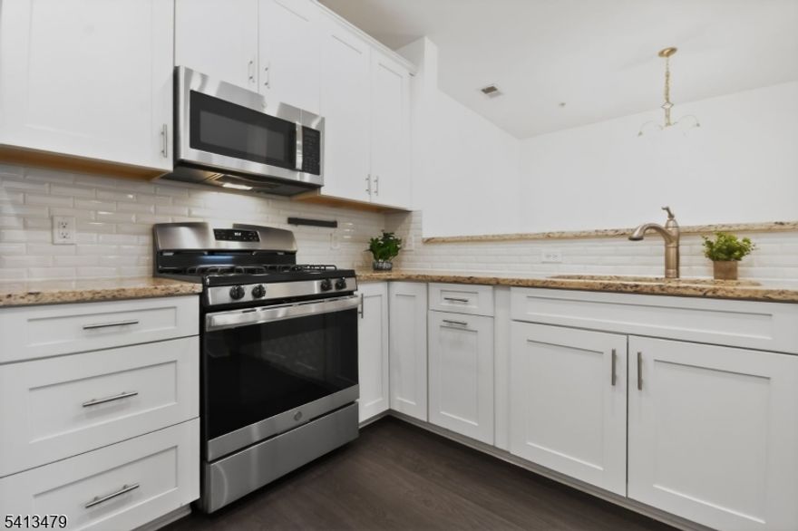 Move-in ready 2-bedroom, 2-bath condo in sought-after Monroe Parke offering easy, low-maintenance living with elevator access. This second-floor unit features brand-new luxury vinyl plank flooring, fresh paint, and an open-concept layout ideal for everyday living or entertaining. The kitchen includes granite countertops, GE stainless steel appliances, and in-unit laundry for added convenience. Both bedrooms offer walk-in closets, a rare find in condo living. Enjoy community amenities including a clubhouse, fitness center, and outdoor pool. Prime location near Route 18, Route 33, NJ Turnpike, shopping, dining, and NYC commuting options.