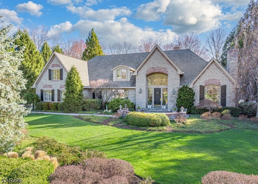 Bewitching Custom Cotswold Estate constructed by renown builder John Avanzato for these original owners in 1997. Fall in Love with this enchanting home with Scenic Water Views from entire rear of home. Meander through a plethora of winding paver walkways, terraced patios, and romantic sitting areas surrounded by gorgeous flowering foliage. Delight in the Luxurious Private Pool and secluded Spa overlooking this captivating property. Elegant 1st Fl Primary Suite exits to the rear yard. Additional En Suite 1st Fl BR w/French Doors to exterior. 2nd Primary En Suite Bedroom with Sitting Rm on the 2nd floor. Elegant Sweeping Stairway to the Front and lovely stairway to the the rear.  Architecturally Delightful Rooms & Living Spaces. Incredible Library, Living Room & Great Room with 3 Tastefully Elegant Fireplaces. Enchanting Voluminous Breakfast Rotunda with water views. Soaring Pella Windows throughout. There is so much to love about this Urban Farms Waterfront Home!