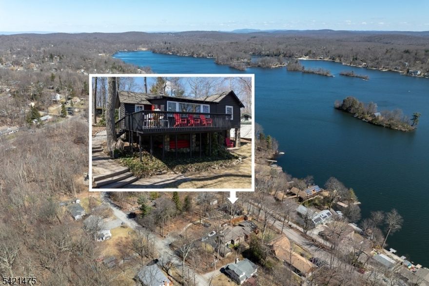 Awaken to spectacular sunrises from this chic, designer cabin in sought-after Highland Lakes. Set on a wooded, double-deep .36-acre lot with dual street frontage (Canadawa), this stylish home delivers cozy sophistication and expansive lake views. Access the lake from either direction leaving the home from two nearby freeways! Start your mornings with sunrise yoga on the expansive east-facing deck. Inside, modern elegance meets rustic charm with two inviting bedrooms and a sleek, updated bathroom. Relax and unwind in the beautifully appointed living area, ideal for cozy winter evenings by the stone hearth. Step outside to discover your own enchanting Path Henge, perfectly aligned for memorable summer sunsets. Gather around one of two fire ring areas and enjoy friendly competitions on the level area perfect for bean bag toss. Keep your beach toys and garden tools stowed out of sight in the unfinished basement or detached storage shed. Enjoy outdoor recreation year-round with private access to five pristine lakes, seven sandy beaches. Activities for all interests and ages; sailing, racket sports, hiking, fishing, swimming, art, music, play group and more. Winter sports are a short drive away at Mountain Creek. With furnishings available separately, this turnkey retreat promises effortless enjoyment. Roof replaced in 2020, Passing Septic Report from 2025 - move in with confidence and embrace lake community living at its finest!