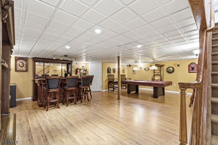 Welcome to this Incredible Brick-Front Home in the much sought-after Wyndham Farm Development. Walk into the sun-filled foyer to a large dining room on one side and an office with French doors on the other. You will find many rooms with crown and chair molding. There is an expansive eat-in kitchen, tastefully updated with granite countertops, a beautiful backsplash, stainless steel appliances, a double-door pantry, a breakfast bar, and a sunlit dining area with sliders to a backyard oasis. There is a large family room featuring a gas fireplace, open to the kitchen. Walk out to the very impressive covered 42 x 16" composite deck, which is perfect for entertaining, but the fun doesn't stop there. Walk down the stairs, and there is a beautiful Blue Haven gunite heated in-ground pool. The pool is fenced in, with gorgeous landscaping and a stamped concrete patio; the spa overflows into the pool. Upstairs are four bedrooms and 2 full baths. The primary bedroom has French doors and an immense walk-in closet w/custom cabinetry. The primary bathroom has ceramic floors, double sinks, a sunken tub, and a shower. The finished basement is unbelievably beautiful, with a gym, a den, and lots of storage, including a cedar closet. The laundry room is located on the first floor with a fully finished washroom. If you are a commuter, the home is located near Routes 78, 22, and 57.