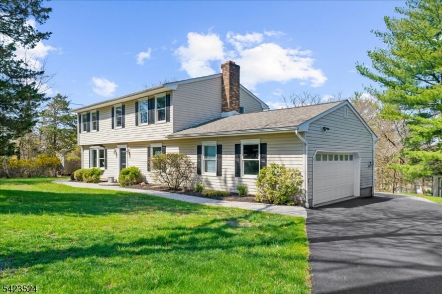 Set in a prime Clinton Township location, this impeccably maintained and thoughtfully updated 5-bedroom, 3.5-bath expanded Colonial offers exceptional versatility and comfort. A welcoming layout features formal living and dining room with built-in corner cabinets and slider to a paver patio. The updated eat-in kitchen boasts granite countertops, stainless steel appliances and generous cabinet storage, with French doors opening to a stunning 25x16 great room. This sun-filled space showcases a cathedral ceiling, pellet stove, refinished HW floor, radiant floor heating, sliders to a gorgeous two-level paver patio, perfect for entertaining and enjoying the beautiful backyard surrounded by mature trees for added privacy. Standout feature is the first-floor in-law suite/apartment with private entrance, offering a full updated kitchen, living area, bedroom, full bath, double closets, and separate laundry. Upstairs, the primary suite includes a walk-in closet and full bath, accompanied by three additional spacious bedrooms and main bath. Additional highlights include a mudroom entry, first-floor laundry, finished walkout basement for recreation and storage, and an oversized two-car garage with workspace. Major updates include a new septic system (2020), new roof (2024), and newly paved driveway (2025). Natural Gas coming to street in 2027. Conveniently located near top-rated schools, highways, shopping, and dining. This is a truly unique and special home in an unbeatable setting.