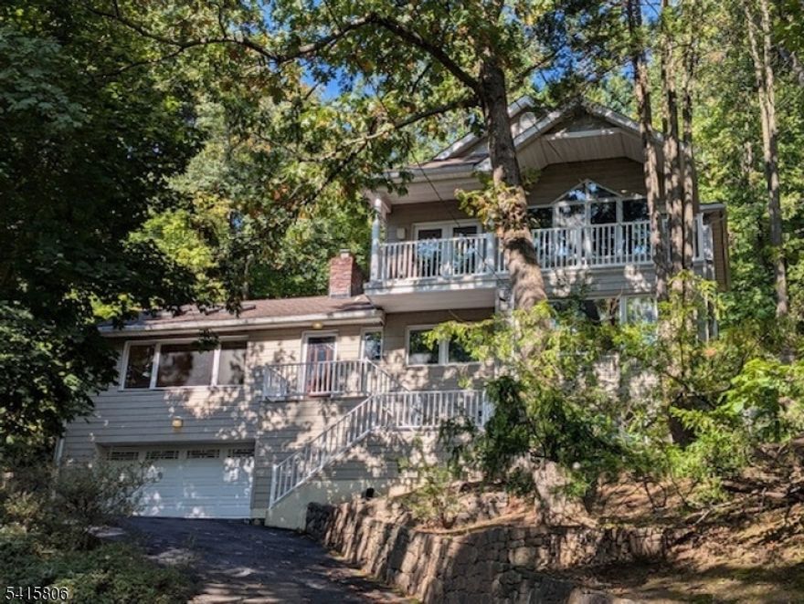 Nestled in the highly sought-after Upper Wyoming section of Millburn and backing directly to the protected South Mountain Reservation, this exceptional expanded ranch offers a rare combination of privacy, natural beauty, and breathtaking views. Enjoy New York City skyline views from this one-of-a-kind property surrounded by mature trees and tranquil woodland scenery.This spacious 4-bedroom, 4-full bath home is designed for both comfortable everyday living and effortless entertaining. Expansive windows invite natural light while showcasing the stunning natural backdrop. The flexible floor plan offers generously sized bedrooms, including an expanded primary suite, and multiple living areas ideal for today's lifestyle.Step outside to your own private sanctuary featuring a picturesque pond and charming waterfall, creating a peaceful, park-like setting rarely found in Millburn. The direct connection to nature combined with the quiet, established neighborhood makes this home truly special.Located just minutes from downtown Millburn, top-rated Millburn schools, Midtown Direct train service, parks, and shopping, this home offers the perfect balance of suburban tranquility and commuter convenience.A rare opportunity to own a private retreat with spectacular views in one of Millburn's most desirable neighborhoods.