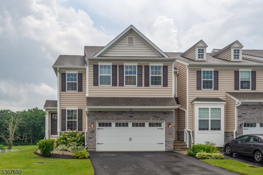 Recently constructed end-unit townhome, is a modern masterpiece! Wrapped in an elegant stone and vinyl exterior, this home reveals a bright, modern layout that invites you to make it your own. The main level makes a strong first impression with high ceilings, oversized windows that bring in a lot of natural light, and an open flow that's perfect for everyday living or hosting. The kitchen shines with granite countertops, custom cabinetry, and a center island that looks out over the living and dining spaces, with direct access to your private deck perfect for entertaining and unwinding while taking in scenic views. A stylish powder bath completes the main level. Upstairs the primary suite, feels like a true retreat featuring tray ceilings, recessed lightning, a spacious closet, and a sleek ensuite bathroom with an easy step-in shower. Two additional bedrooms share a Jack and Jill bathroom; and the laundry room is smartly located on this floor for convenience. Downstairs the fully finished walkout basement, adds even more flexibility with a third full bathroom, and space for a home-office, gym, or guest area. The two-car built-in oversized garage with a two-car width driveway ensures a more convenient off-street parking. This impressive, move-in ready, dream townhome got the space, and style, A rare find! Just waiting for you to make it yours. This listing is also for rent.