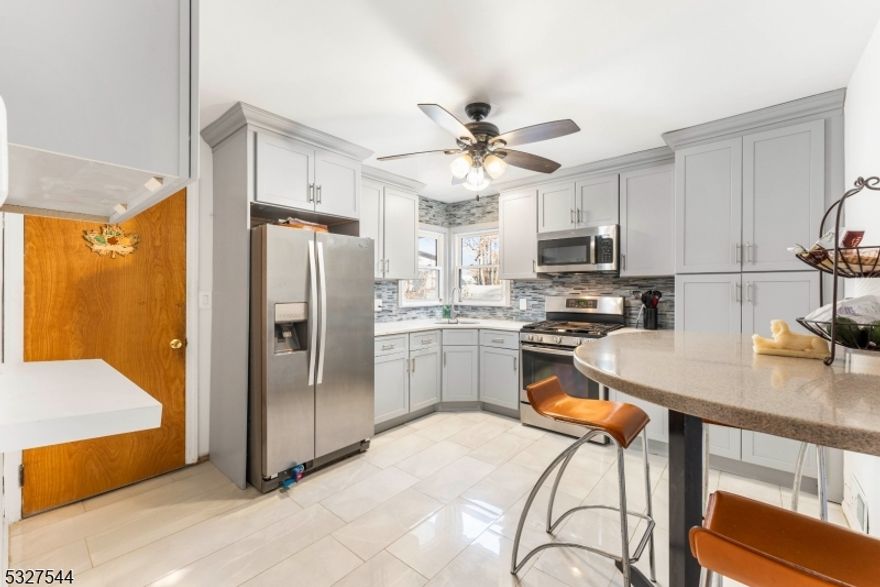 This beautifully updated Cape Cod-style home offers a perfect blend of comfort, convenience, and charm. Located on a desirable corner lot just two blocks from bus service to New York City, this property is perfect for commuters seeking a tranquil retreat close to everything. Inside, the home features three bedrooms and 1.5 baths. The updated kitchen and bathrooms showcase modern finishes, blending style and functionality. The second-floor master bedroom includes a cozy sitting area, providing a private and relaxing space plus new ductless AC and heating. A bright Florida room adds extra living space and is perfect for enjoying your morning coffee or unwinding in the evenings. The full finished basement offers a family room, a bar for entertaining, an additional room currently used as a music studio, and a convenient laundry area. Upgraded Electric and plumbing and new roof. Outside, the fenced-in yard ensures privacy and is perfect for outdoor gatherings or play. A detached garage completes the package, adding additional storage or workspace options. This home's excellent location, thoughtful updates, and unique features make it a true gem. Don't miss the opportunity to make it yours!