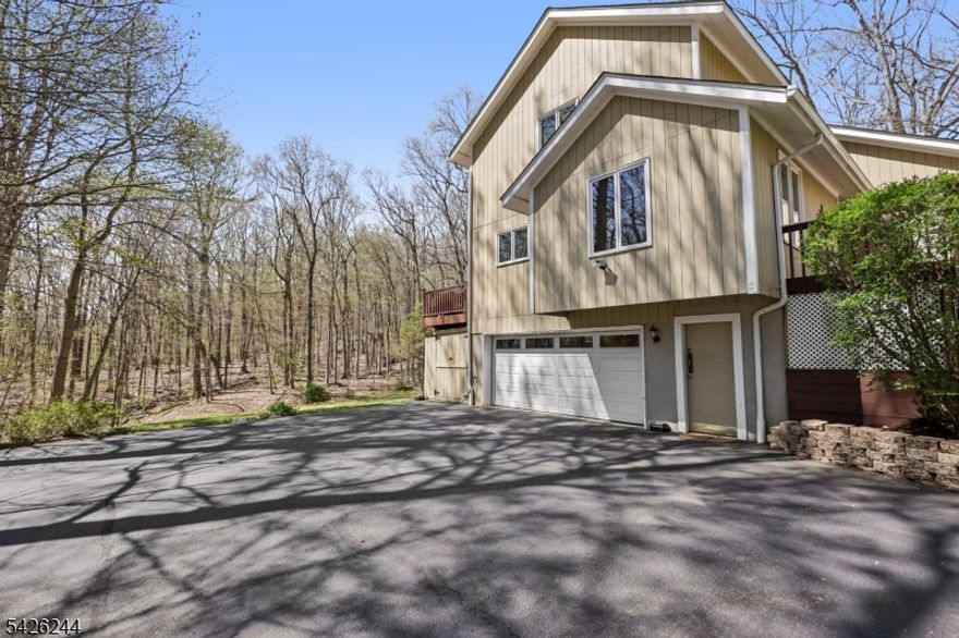 Tucked away on nearly an acre of private, wooded property, this striking contemporary home at 53 Lee Hill Road offers the perfect blend of style, space, and serenity. Featuring 4 bedrooms, 2 full baths, and 2 half baths, this home is designed for both everyday comfort and effortless entertaining.Step inside to a dramatic vaulted living room with skylights that flood the space with natural light, anchored by a cozy fireplace. The first-floor primary suite provides true convenience and retreat, complete with a jetted tub for relaxing at the end of the day.The outdoor setting is where this home truly shines. A spacious TREX deck overlooks peaceful, wooded surroundings with no homes in sight your own private escape. Just beyond, enjoy a dedicated hot tub deck and fire pit area, perfect for quiet evenings or gathering with friends.The walk-out lower-level family room offers added living space along with a convenient half bath ideal for easy access from outdoor entertaining areas.A rare opportunity to own a home that delivers privacy, modern design, and a connection to nature all in a desirable Byram location.