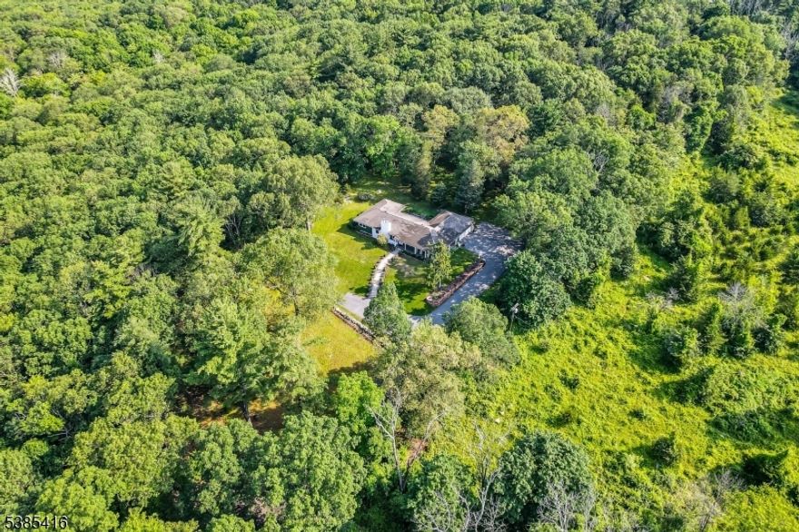 Discover a rare opportunity to own 29 acres of scenic land in Boonton Twp. This unique property includes a renovated ranch-style home with several different possibilities.  This beautifully renovated ranch-style home offers three spacious bedrooms and two full bathrooms, blending comfort and functionality. The inviting living areas feature an open layout with plenty of natural light, perfect for everyday living and entertaining. The kitchen boasts modern updates and connects seamlessly to the dining and living spaces. A finished lower level provides additional versatile space for recreation, a home office, or storage. Outside, enjoy a secluded patio and deck ideal for relaxing or hosting gatherings. Completing the home is an attached garage, offering convenience and extra storage.  The expansive acreage offers rolling woodlands, open fields, and stunning natural surroundings, providing ample space for other facilities including pool, or recreational amenities. Ideally located with access to major highways, NYC transit, dining, and shopping, this property combines privacy with connectivity. Whether envisioned as a larger home, 119 Kingsland Rd offers the perfect setting to bring your vision to life.