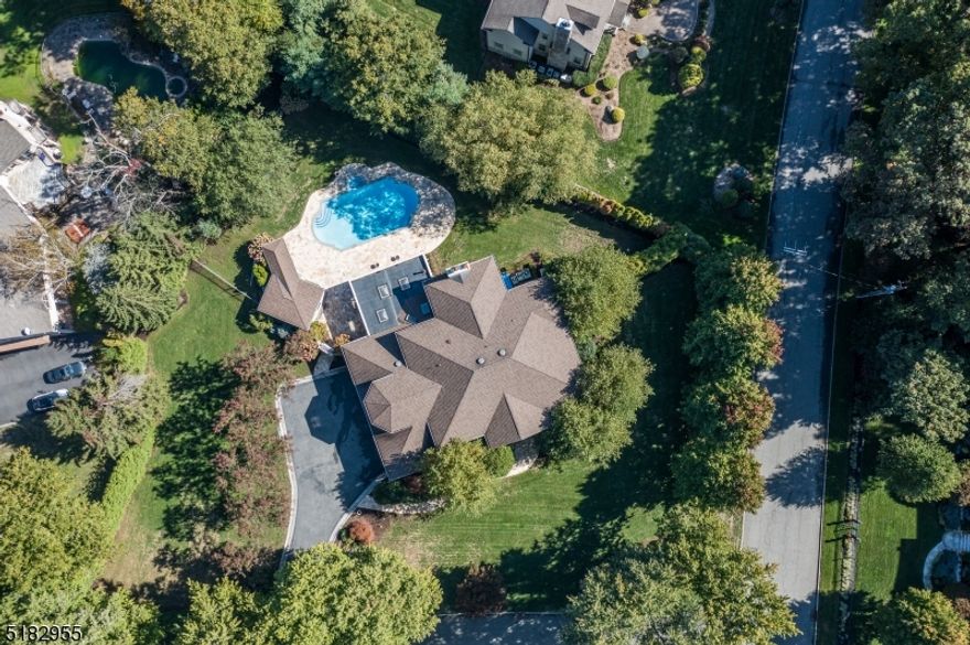 A magical oasis with lush landscape envelopes you into a fairy tale resort-like property upon arrival. A covered patio featuring a fireplace and pizza oven, overlooking the heated gunite pool and cabana, suitable only for the most discerning buyer who understands luxury. Stunning 18' entry foyer with custom trim work, formal LR, banquet sized DR, a great room with coffered ceilings and a wet bar to showcase your private collection. A custom cherrywood office is the perfect spot to transact your biggest deals. On the 2nd floor you will find the gorgeous primary suite with fireplace, and spa like bath with a steam shower, 4 additional bedrooms and a laundry. Full finished basement with a full bath and wine cellar. The home features a 3 car garage with 2 lifts. This home checks all of the boxes.