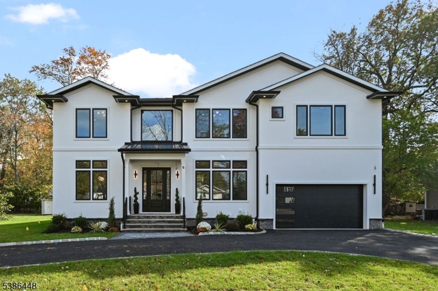 Welcome to this stunning 6-bed, 6.5-bath custom new construction home offering approx. 5,100+ sq ft of finished living space across 3 expansive levels, ideally situated on a 0.35 acre FLAT lot with Circular Driveway. The main floor is thoughtfully designed for modern living & entertaining, with a Covered Front porch entry into a dramatic 2-story foyer. Wide-plank HW floors & detailed custom trim set the tone throughout. The formal dining room flows seamlessly into the chef's kitchen, featuring high-end stainless steel appliances, quartz countertops, a center island with seating, a walk-in pantry, & a butler's pantry. The open-concept layout continues into the spacious Family room with 20ft Ceiling family room, anchored by an electric fireplace with Stone cladding & sliders open to a paver patio, a private guest suite w/ full bath, mudroom, powder room & convenient access to a two-car garage. Upstairs, the luxurious primary suite serves as a peaceful retreat with a private balcony, large designer WIC, & a spa-like bath feat. double vanities, a soaking tub, glass-enclosed shower. Three additional bedrooms are all en-suite, each w/ custom WIC; a laundry room with built-in cabinetry & sink for added convenience. The fully finished basement offers a large recreation room with a Wet Bar, media room, Exercise/Gym/Office room, 6th bedroom, full bath, & ample storage. 10-Year Builder's Warranty