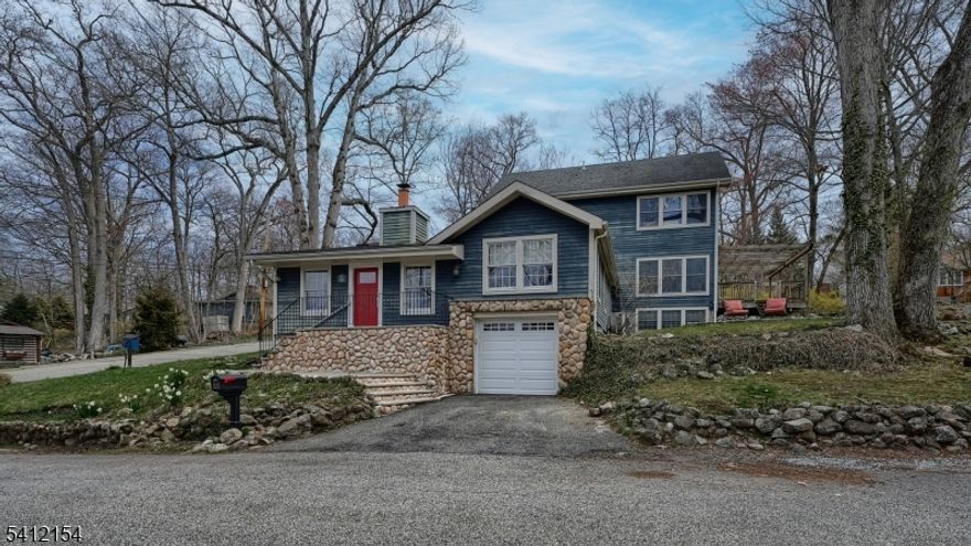 A rare blend of Pines Lake charm & modern living, this custom 4 Bedroom, 2.1 Bath home offers approx 2,500 sq ft of character-filled space. Enter into a stunning Great Rm w/ vaulted ceilings, skylights & a dramatic stone wood-burning fireplace, surrounded by natural light & access to a private courtyard. A split-bedroom layout features 2 Bedrooms w/ barreled ceilings & log walls, plus a beautifully updated shared Bath. Just steps up, enjoy a spacious Living Rm, Office area & Powder Rm. The gourmet Kitchen is appointed w/ granite countertops, SS appliances & a separate Dining area, flowing seamlessly to a custom deck w/ pergola showcasing breathtaking lake views and sunsets perfect for entertaining. Multiple patios & yard spaces enhance the outdoor experience.The top level offers a bright Primary Retreat w/ full Bath & an additional Bedroom. The ground level adds flexibility w/ Office, Rec Rm, Laundry, Mudroom, storage & access to the basement & oversized garage.Updates include newer systems & front and patio doors. Enjoy Pines Lake lifestyle w/ private beaches, boating, sailing, tennis, pickleball & scenic trails.