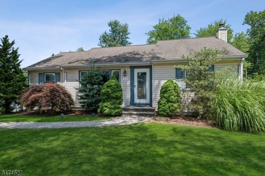 Quiet, comfortable, convenient!  Wonderful, 1954 mid-century Ranch on a tree-lined street in Whippany offers three bedrooms, two full bathrooms, a fenced-in back yard, and one attached-car garages. With easy access to Routes 287, 10, and 24, this home is close to schools, shops, multiple restaurants, and the forty-acre Central Park offering ball fields, a playground, picnic areas, and walking paths. Situated on a landscaped lot with an extra-wide driveway for plentiful parking, a large storage shed, a sweeping front lawn and stone paver walkway lead you inside to a light and bright interior with hardwood floors. The large living room includes a pass-through to the kitchen and glass sliding pocket doors to the dining room with a chair rail and lovely arched window. Skylights in the eat-in kitchen create a bright and sunny ambience with stainless steel appliances, ample counter and cabinet space, and room for a dinette set. Off the kitchen is a deck with built-in benches overlooking the stone paver patio and privacy-fenced back yard. The primary bedroom has a full en suite bathroom, while two additional bedrooms share a full hallway bathroom. Additional living space on the basement level includes a spacious recreation room with a wet bar, a laundry room, access to the attached garage, and plenty of storage