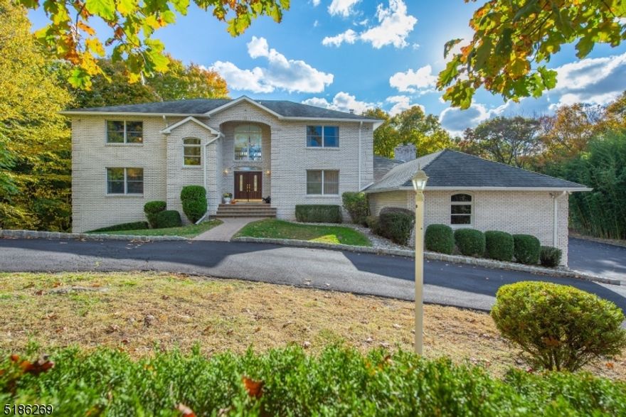 Nestled on an enchanting 2+ acre property in Raine Tree Estates, this sprawling  contemporary colonial offers privacy and breathtaking views. From the soaring two story entrance open to the elegant formal DR and spectacular GR featuring a wall of floor to ceiling windows w/sliders to an expansive deck, the natural and peaceful setting will capture your heart! Sip coffee in the sunny Kitchen w/center island and Breakfast Room open to the inviting FM w/gas fireplace and sliders to the deck. Powder Room, Laundry and access to the garage are located off this wing while an expansive 1st floor BR w/a crisp hall bath w/tub/shower plus an adjacent office could easily be a private guest area.  Ascend the stunning stairwell to the open bridge leading to expansive 2nd level. Primary suite features 9 ft. tray ceiling, hardwood floors & luxurious bath w/skylight, double vanity & tiled shower w/glass door. 3 additional expansive bedrooms w/hardwood floors and ample closets share a large hall bath w/double vanity and tiled shower/tub. An incredible, full finished walkout lower level,  allows for fabulous additional living space! Boasting a spectacular recreation room, well-equipped full kitchen w/marble hearth. A full bathroom allows for a flexible floor plan. Sliders open to the tranquil property & invite one outside to commune w/nature! A three oversized garage allows for ample storage.  A special oasis w/ room for everyone on the most enchanting, bucolic property! Built for entertaining