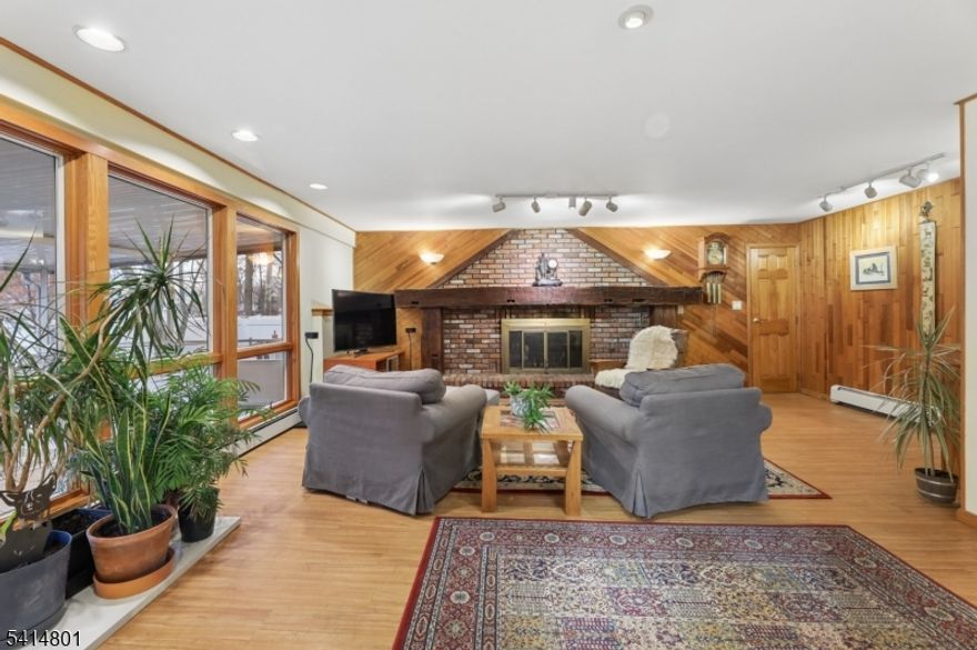 Imagine enjoying your morning coffee in a peaceful screened-in porch or relaxing by the wood-burning fireplace on a chilly evening.  Welcome to this inviting home with unique features set on a desirable corner lot property. You will find classic style and everyday convenience in this beautiful 3-bedroom, 1.5-bath home. Located in the heart of Oakland, you'll be just minutes away from schools, shopping centers, parks, houses of worship and NYC transportation. Interior Highlights:  Inviting Living Spaces: The spacious living room features vaulted beamed ceilings. Step down to the cozy family room boasting a unique decorative wood and brick accent wall with a wood-burning fireplace and honed mantel perfect for chilly evenings.  Open & Airy Layout: Enjoy a seamless flow between the living room,dining area and kitchen, ideal for both daily meals and holiday hosting. Outdoor Living:  Relax in your private screened-in porch or head out to the patio " perfect for summer BBQs, outdoor fun or just relaxing. Nestled in a desirable Oakland neighborhood with convenient access to everything you need, this home offers comfort, charm and an unbeatable location. Come and see why this home feels special the moment you walk in.