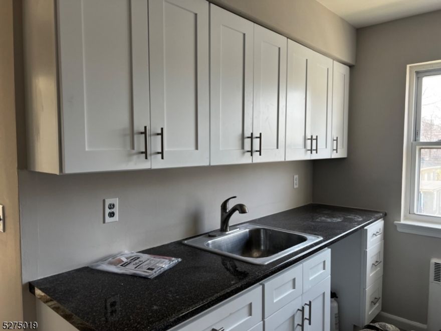 Welcome to this bright and freshly painted top-floor apartment offering privacy and comfort with no one above you. Enjoy hardwood floors throughout and a brand-new white kitchen complete with stainless steel appliances including a refrigerator, microwave, and dishwasher. The apartment features a tiled bath, wall-mounted air conditioner, and generous closet space. On-site laundry and off-street parking (for an additional fee) add convenience. Heat, hot water, and gas are included tenant only pays electric. Ideally located near major highways and public transportation, this move-in-ready home is perfect for commuters. Docuverus tenant screening required.