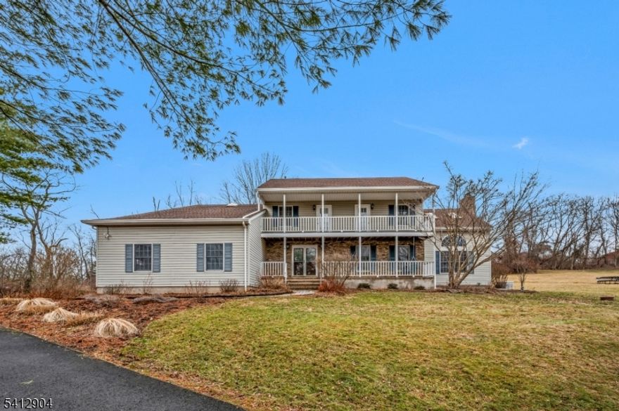 Set on a picturesque 2.62-acre property in desirable East Amwell Township, this spacious Colonial offers the perfect blend of privacy, comfort, and functionality. Featuring 4 bedrooms and 2.5 bathrooms, this well-maintained home provides over 3,000 square feet of living space designed for everyday living and entertaining. The main level showcases a welcoming foyer, formal living and dining rooms, and an expansive kitchen with generous workspace, and a walk-in pantry. A large family room and separate library each feature their own wood-burning fireplace, with the library also offering built-in shelving around the room, creating warm and inviting spaces throughout the home. Cathedral ceilings, skylights, and abundant windows bring in natural light and enhance the open feel. Upstairs, the primary suite offers a private retreat with a full bath and walk-in closet, while three additional bedrooms provide flexibility for guests, home office needs, or hobbies. Additional highlights include a full unfinished basement with bilco-style doors, convenient first-floor laundry, and an attached 3-car garage. Outdoor features include an open porch, rear deck, and a beautiful mix of open and wooded land ideal for enjoying the peaceful Hunterdon County setting. Conveniently located near Route 202 while still offering a serene country atmosphere, this property presents a fantastic opportunity to own a spacious home on acreage in sought-after East Amwell.