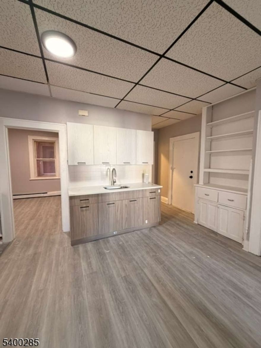 134 E Jersey St, located in the Elizabethport section of Elizabeth, offers a fully renovated 2-bedroom, 1-bath apartment featuring a bright living area, upgraded kitchen with modern cabinetry, stove and fridge included, and well-sized bedrooms with ample natural light. The bathroom includes tile finishes and updated fixtures. Cold and hot water are included in the rent. Conveniently situated near NJ Transit bus lines, the Elizabeth train station, local schools, shopping centers, parks, and the Elizabeth Waterfront, this location provides easy access to Newark, Jersey City, NYC, and major highways.