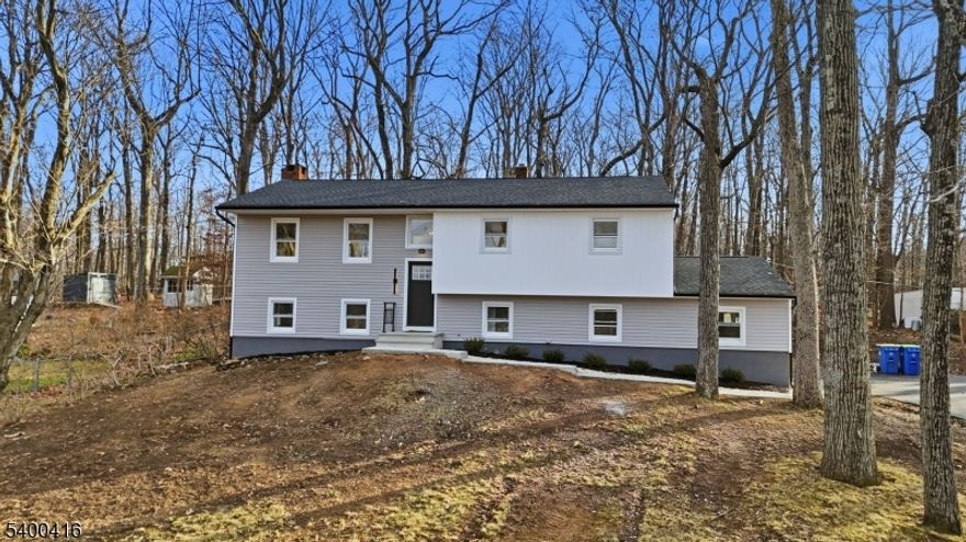 Stunning 2025 full renovation in one of Bridgewater's most desirable neighborhoods! This turnkey 4-bed, 3-bath home blends modern luxury with exceptional craftsmanship. The main level features new hardwood flooring, recessed lighting, and a spacious living room centered around a custom electric fireplace and built-in media center. The designer kitchen showcases quartz counters, soft-close cabinetry with accent lighting, chevron marble backsplash, matte-black stainless steel appliances, pot filler, and a custom farmhouse hood. Dining area opens to an expansive 30x30 Trex composite deck overlooking the newly landscaped property. The main level continues with a serene primary suite featuring a custom glass-enclosed shower and oversized closet, plus two additional bedrooms and a stylish hall bath. The walkout lower level offers incredible versatility with a large recreation/entertainment space, wood-burning fireplace, custom dry bar with beverage fridge, full bath, 4th bedroom/office, mudroom with garage access, and separate laundry area.Exterior upgrades include new Craneboard Solid Core luxury siding (lifetime), brand-new roof (architectural shingles w/ lifetime warranty), updated energy-efficient windows, new driveway, new walkways, new firepit patio, and refreshed landscaping. Major mechanicals updated: 200-amp electrical, new 50-gal water heater, and Goodman HVAC. Nothing to do but move right in and enjoy luxury, comfort, and modern living at its finest!