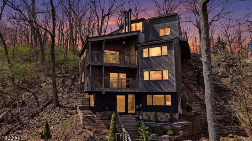 Bring your vision and unlock the full potential of this remarkable property, in an unbeatable location.Perched above the treetops in sought-after Upper Montclair, this one-of-a-kind vertical treehouse offers a rare opportunity. Set into the dramatic cliffs of Mills Reservation, this home blends privacy, and nature while capturing breathtaking, unobstructed views of the Manhattan skyline from every window. This architecturally distinctive residence features 4 bedrooms and 3.5 baths, with dramatic living spaces defined by soaring ceilings, a striking central domed skylight, and three slate gas fireplaces that add warmth and character throughout. A sculptural spiral staircase anchored by a vintage chandelier sourced from the Guggenheim Museum serves as the home's artistic centerpiece. The backyard patio provides a peaceful retreat with direct access to the scenic trails of Mills Reservation. Perfectly balancing tranquility and convenience, this home is just a short walk to the Midtown Direct train for effortless commuting. Nearby, Mountainside Park offers a variety of recreational amenities, including tennis courts and a pool, while the lively shops and restaurants of Upper Montclair Village are all less than 1 mile away.