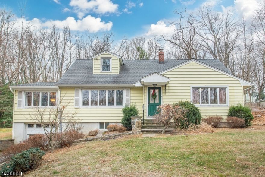 Charming Expanded Cape Cod 4 Bedrooms, 2 Bathrooms. Set on   of an acre of beautifully landscaped property, this expanded Cape Cod offers comfort, character, and a prime location close to the Lake Valhalla Club in Montville Township. The main level features two bedrooms, a full bathroom, a kitchen with stainless steel appliances, a cozy breakfast area, a dining room, living room, and a convenient laundry room. The second floor includes two additional bedrooms and another full bath.The basement is semi-finished and provides access to the garage, offering generous recreational space and ample storage. Discover all that Montville Township has to offer, from top-rated schools and acclaimed restaurants to easy access to major highways and NYC transportation. Just a few minutes drive to the NYC bus and Towaco Train Station, this home combines suburban tranquility with commuter convenience.