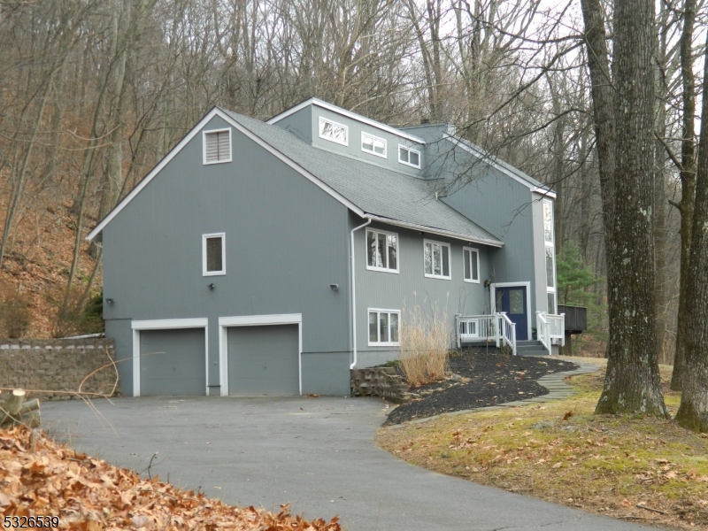 Charming Contemporary Home on 7+ Wooded AcresNestled on over seven acres of serene, wooded property, this elegant four-bedroom, 3.5-bathroom contemporary home offers a perfect blend of modern comfort and classic style. The spacious interior boasts an inviting layout, with a sunlit living room, a formal dining area, and a cozy family room featuring a fireplace. The kitchen is a chef's dream, with ample counter space, updated appliances, and a breakfast nook overlooking the lush backyard.The main floor hosts the owners suite, complete with a private bath and walk-in closet, along with three generously sized bedrooms and a shared full bath. A finished lower level provides additional space for a home office, gym, or recreation area.Step outside onto the expansive back deck, perfect for entertaining, relaxing, or enjoying the natural beauty of your private retreat. Whether hosting gatherings or savoring quiet mornings, this outdoor space makes the most of its tranquil, wooded setting.This property combines the charm of contemporary architecture with the luxury of privacy and space, offering a unique opportunity to own a slice of nature while being close to local amenities. Don't miss the chance to make this stunning home your own!