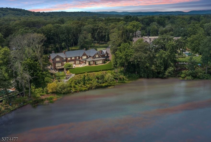 Where Dreams Touch the Water! Welcome to an extraordinary lakefront estate where timeless beauty meets tranquil living undoubtedly one of Franklin Lakes' most captivating treasures. Set on 2.7 magical acres along the shimmering shores of Franklin Lake, this enchanting all-brick  Manor was thoughtfully designed as a creation of elegance & warmth. From the moment you arrive, peace & quiet grandeur surrounds you. The slate roof, curved lines, & graceful architecture speak to a home built not just with materials, but with intention. Inside, a story unfolds across 13 rooms of refined comfort & charm. Curl up with a book in the richly paneled great room/library, gather by the fire in the sunlit grand living room, or savor mornings in the breakfast room, wrapped in light with breathtaking lake views. The heart of the home an artisan kitchen with twin islands & handcrafted details opens to a 24x31 family room with a wall of windows. Upstairs, the primary suite is flooded with light, framed by nature, & enhanced with his & her dressing room/closets & exquisite marble bath & steam shower. A walk-out lower level is pure joy offering spaces to play & gather from the game/media rooms to a Pub room with wet bar. A heated driveway welcomes you home in every season, while the grounds invite morning coffees overlooking the lake & unforgettable sunset dinners under the stars. This is more than a home- it is a once-in-a-lifetime chance to have land, light, & luxury a true sanctuary on the lake!