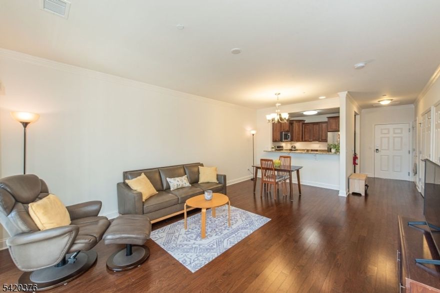 Active Adult 55+ Community with Country Club Lifestyle. Large Living Room with Open Floor Plan to Dining Room. Kitchen w/ plenty of Cabinets, SS Appliances.& Granite Counters. Den could be used for Guest Room or Office. Plenty of light. HW Floors ! Primary Bedroom has Sitting area or Office nook and FULL Bathroom w/ Walk in Shower. Laundry in Condo w/ side by side Washer & Dryer included. Entire Condo freshly painted within past 6 months. Covered Terrace- Privacy & View of trees. An Assigned Parking Space in Garage & a Large Storage unit. READY for you to just MOVE IN ! Good Location in Community. Just a short walk to the Beautiful Upscale Clubhouse-16,000 sq. ft. with it's Resort like Amenities- Indoor Pool & Sauna, Fitness Center, Aerobics/Dance Room, Game/Card Rooms, Art Studio, Banquet Room, & MORE !! Large Outdoor Pool, Picnic Pavilion with gas grills, Tennis/Pickleball Courts, Walking Paths, & Community Garden. FULL Social Calendar. Gated Community in a Parklike neighborhd setting. Convenience is key- Nearby Mall, Rt. 80, Shopping, Restaurants, Dr. Offices, NY Transportation, (both Train & Bus) Golf, & Parks. Embrace an Active Lifestyle in a Community that offers Many Amenities & Activities for a fulfilling & enjoyable life !