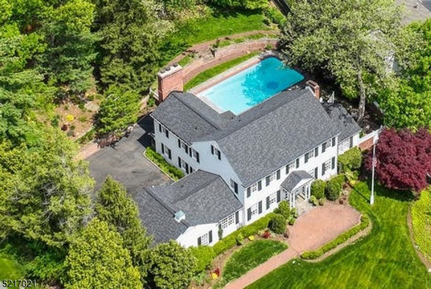 Sensational 5 Bed, 4.2 Bath (including a 1st floor suite with full bathroom) custom colonial situated on approximately two-thirds of an acre of gorgeous property. Exquisite designer finishes with numerous updates and upgrades throughout + fabulous outdoor entertainment spaces including a spectacular inground pool! Located on quiet street in Hartshorn section, this home provides luxurious living without ever leaving the property. Front-to-back Living Room with built-ins overlooks rear yard and opens to Office/Sunroom with direct patio access. Formal Dining Room provides access to kitchen and is open concept to stunning Family Room with beamed ceilings and easy access to pool + to 2-car garage and parking. 1st floor en-suite Bedroom features renovated bathroom with radiant heated floor + walk-in shower. 2nd level features 4 Bedrooms (2 are en-suite), 3 Full Baths. Primary Wing includes fireplace, balcony overlooking the rear grounds, 4 closets and bathroom with tub and separate shower. 3 other bedrooms (one en-suite) all have large closets and plenty of sunlight + Full Hallway Bath. Lower Level Rec Room with built-ins and storage features new carpeting and options for fitness or entertainment. Large storage room has abundant cabinetry, a laundry area and a utility bathroom. Spectacular yard and resort-like swimming pool provides multiple entertaining areas, covered porch, blue stone patio, magnificent hardscaping and lush gardens. Must See TODAY!