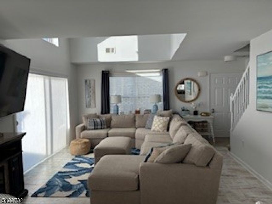 SHORT TERM RENTAL OPPORTUNITY!  New 4th bedroom was just added and interior being painted this week! Rental can start  January 5 -May. Minimum 3 month rental flex term. Utilities included. Clean bright 11 year old elevated home on the water - direct water views and access. Fully furnished - 4 bedrooms - 2 primary suites - 3 full bathrooms. Spacious home, super clean, comfortable - light and bright! White kitchen with center island - new 2025 white quartz counters and stainless steel appliances. Full size washer dryer. Ample parking in private driveway. Large Deck and patio perfect for relaxing and entertaining.  Super convenient location - 5 min walk to minimart, pizza, bagels, ice cream and more.