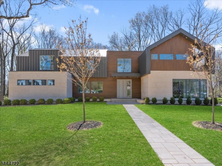 Newest project by AHM Architects & CV Building in the prestigious Hartshorn section of Short Hills. An architectural showpiece featuring 6 beds (all with en-suites), 6.5 baths, approximately 7,500 square feet of grand living space, open floorplan w/ cathedral ceilings & views of greenery from expansive Dor-Win windows. This impressive home is pre-wired w/ Crestron Home Automation lighting system. 6"oak floors & meticulous detail throughout. 8' high/2" thick solid wood doors with YALIS hardware & a custom floating wood & glass staircase welcome your guests. Gourmet St. Martin kitchen w/ Quartzite waterfall countertops, high-end appliances & walk-in pantry. Striking family room details include gas fireplace w/ book-matched stone & mirrored bar w/ wine fridge. Expansive, yet serene, primary bedroom suite w/ soaring ceilings, custom WIC & spa-like bath w/ heated floors & sitting rm w/ gas fireplace, additional home baths all w/ radiant heated floors. Modern conveniences include a 1st-floor in-law suite, large home office/2nd family room and 2nd fl laundry. Finished lower level guest room w/ en-suite bath and rec room. Oversized two-car garage (possible to add a garage lift, increasing capacity to a four-car garage). Enjoy both the back and side yard from the spacious Trex deck for multiple balconies. 4 zone heating and cooling system. Distinct and unique, timeless natural materials are infused throughout this home's sleek spaces.