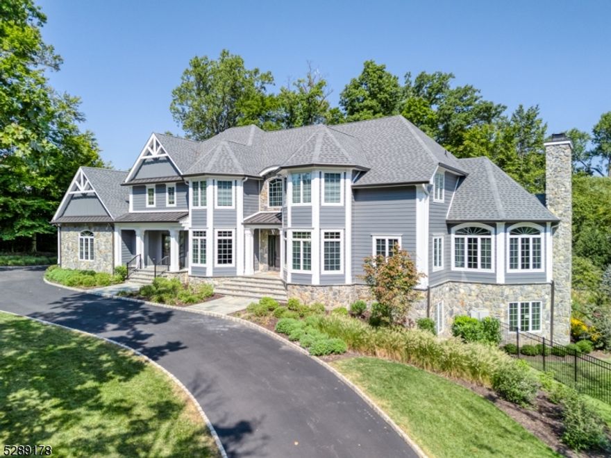 An entertainer's dream home! Located in one of the most desired luxury neighborhoods in Warren, Reflections, this stunning 6BR, 5.1 BA Colonial, set on 1.23 acres, is close to Rt 78, Pingry School, numerous restaurants & shops & adorns exquisite millwork, new Hardi-plank w/ Azek trim & stone siding, circular driveway, 4 car garage + over 7,000 sq ft of luxury living spaces on 1st, 2nd + walk-out lower level. The showstopper backyard oasis was completed in 2023, w/ its glorious salt water heated pool, fenced-in yard, stunning landscaping, covered stone patio w/ full outdoor kitchen featuring custom pizza oven, TV, heaters, music & gas FPL! Gracious 2 story foyer, LR, DR, convenient main home office + desirable 1st fl guest ensuite, gourmet kitchen w/ high end appliances, wood cabinetry & center island, huge pantry & access to deck, opens to 2-story, sun-filled breakfast room & to the spacious family room, a favorite place to gather w/ its gas FPL and wall of windows with views of the backyard! 2nd fl features Primary BR ensuite w/ tray ceiling, views of backyard, gas FPL, sitting area, large custom walk-in closet & ensuite bath. 3 add'l BRs, one ensuite BR & one Jack & Jill w/ full BA. Finished (2,000 sq ff) walk-out lower level has BR ensuite w/ full bath, media rm, gym, 2nd home office, rec rm w/ FPL & 2nd kitchen & 2ne laundry rm, ideal for multi generational living. New Roof, New maintenance-free Deck & 3 units HVAC in 2023! Water heater ('18). Public Water, Public Sewer.