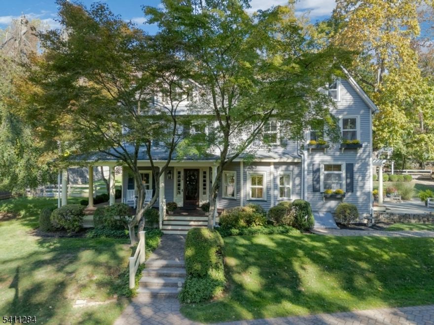 This romantic farmhouse is set on a picturesque property in Watchung. Prestigiously renovated C. 1840 farmhouse blends timeless character with modern updates. From the moment you arrive, the inviting wraparound porch, private cul-de-sac setting & charming light-post-lit driveway create an unforgettable first impression-you'll fall in love before you even step inside.  The heart of the home is the stunning addition, which features a sun-filled great room with radiant heated floors, soaring coffered ceilings & a dramatic stone fireplace ideal for everyday living & elegant entertaining. Wide-plank floors & custom finishes flow seamlessly into the chef's kitchen with two ovens, 5-burner cooktop, custom stone flooring & beautiful cabinetry. Just off the kitchen, the bluestone patio extends the living space, perfect for outdoor dining, relaxing & entertaining. The formal living room showcases a striking stained-glass window & original chestnut mantel. Upstairs, spa-inspired baths shine. The hall bath offers a claw-foot soaking tub & double vanity. The third floor includes a full bath, a large bonus room/fourth bedroom & cedar closet. A detached two-car garage with a walk-up attic adds storage & future potential. With 3 bedrooms, 2.5 baths & a serene Watchung location near town, top-rated schools & commuter routes. This is a rare opportunity to own a truly special home where charm meets modern living.