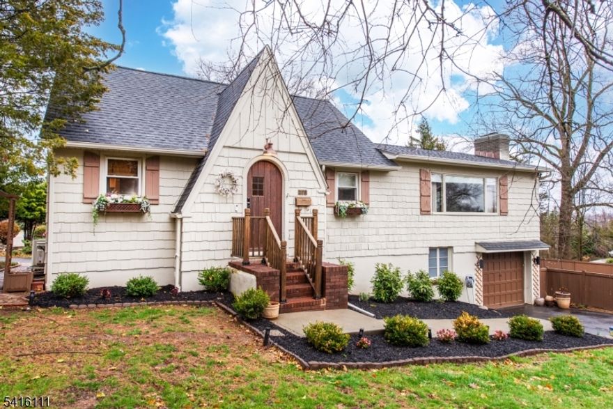 Welcome to this oversized Cape Cod perfectly situated on a large corner lot. This home offers the space and versatility you've been searching for with four comfortably-sized bedrooms, one full bathroom, and one half-bath. The heart of the home is designed for seamless daily living and effortless entertaining.  Say goodbye to clutter with a spacious mudroom! This oversized feature offers abundant storage and integrated seating, making it the perfect transition space for a busy household. Relax in the inviting living room or host dinner parties in the dedicated dining area and a functional eat-in kitchen for casual meals. Step outside to find a private side yard, fully enclosed with a privacy fence an ideal spot for weekend entertaining, gardening, or simply relaxing in your own quiet retreat. This property boasts two separate driveways with garage door access from both the front and back of the house. The basement area features a walk-out to the built-in two-car garage, providing easy access for vehicles and additional storage. Location is everything! NJ Transit Bus stop at your corner providing direct service to the Port Authoriy Terminal (NYC). Access to Routes 46, 80, and 23 is just moments away, simplifying your daily travels and minutes away from a wide variety of local activities, shopping, and dining. Don't miss your chance to own this versatile and well-located gem! Call for a private showing today.