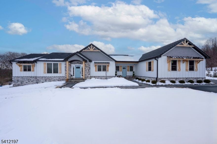 THIS EXQUISITE 2-YEAR-OLD CUSTOM RANCH CAPTURES ELEGANT COUNTRY LIVING BLENDED WITH MODERN SOPHISTICATION. Designed for refined single-level living, this thoughtfully crafted home offers comfort, craftsmanship, and a tranquil setting.A sweeping approach reveals striking architectural presence. Inside, natural oak hardwood floors, soaring 16-foot vaulted ceilings, grand great room creates warmth and understated luxury. A wood-burning fireplace with a custom shiplap feature wall anchors the space, perfect for intimate evenings or gracious entertaining.Gourmet country kitchen features granite countertops, premium stainless steel appliances (all 2 years old), a generous pantry, and an expansive breakfast bar flowing into a sunlit dining area ideal for gatherings.Sliders open to a private outdoor retreat with a newly installed in-ground heated pool, manicured grounds, and a spacious deck complete with privacy wall, ambient lighting, and powered awning for seamless indoor-outdoor living.Primary suite offers hardwood floors, a walk-in closet, and a spa-inspired bathroom.  3 additional bedrooms, a mudroom with first-floor laundry, and recessed lighting complete the main level.A full walk-out basement offers endless expansion possibilities. A 3 car garage, whole house generator, stone pillars, split-rail fencing, and curated landscaping enhance the estate setting.With 8 years remaining on the builder's warranty. Exceptional property offers modern luxury in a timeless country setting.