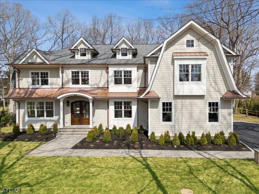 Experience timeless elegance in this exceptional Dutch Colonial offering 7 bedrooms, 7.5 baths, and four levels of beautifully designed living space. Set on a rare .74-acre level lot on a picturesque, tree-lined street in Madison's prestigious Hill Section, this home blends classic architecture with modern luxury. Highlights include 7" white oak floors, 10' ceilings on the first floor, and designer finishes throughout, including Visual Comfort and Serena & Lily lighting and Italian silk wall coverings. The stunning kitchen features a custom copper hood, high-end appliances, oversized island with seating for five, walk-in pantry, and both wet and dry bars ideal for entertaining. The lower level includes a fitness room with floor to ceiling mirror, custom wine wall, full kitchen, and guest suite. Exterior features Hardie shake siding, copper accents, bluestone patio, outdoor kitchen with refrigerator, speakers, and a natural stone wood-burning fireplace. Expansive, level yard perfect for a pool and outdoor entertaining.